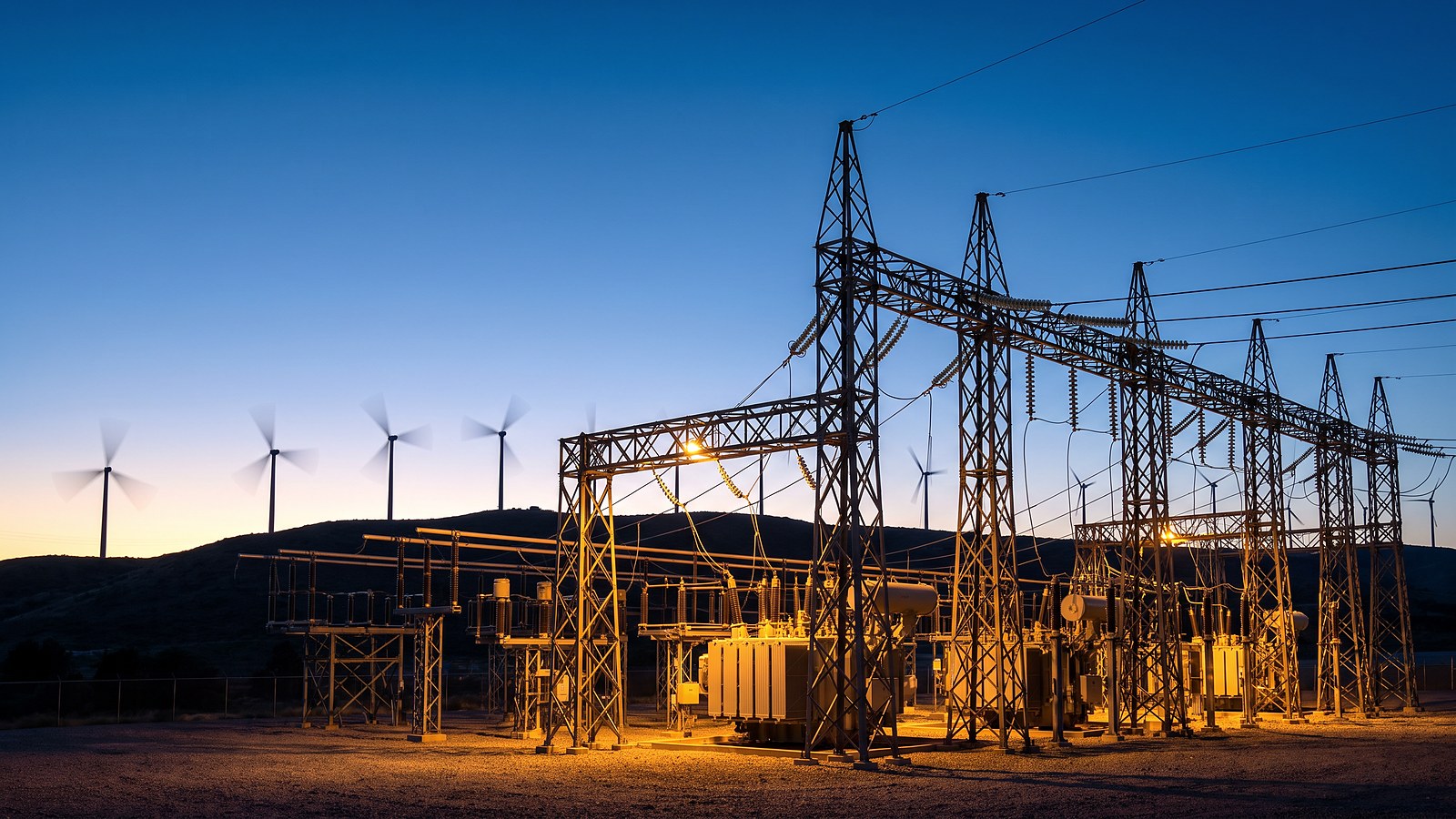 Electrical substation and transmission towers at dusk